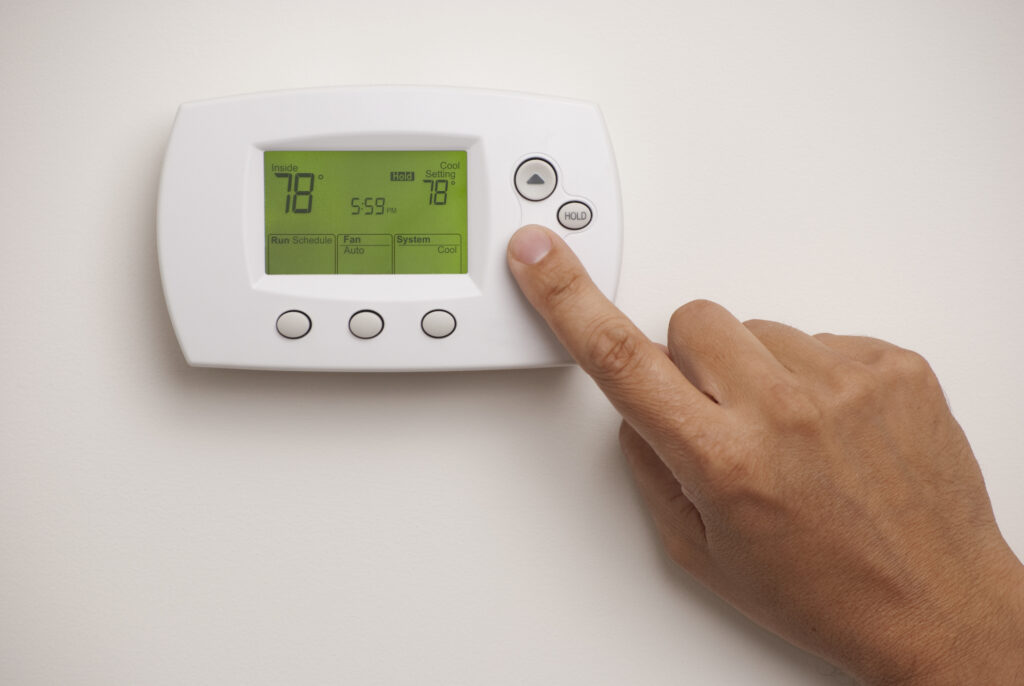 Male Hand On Digital Thermostat Set At 78 Degrees Dakota Electric 